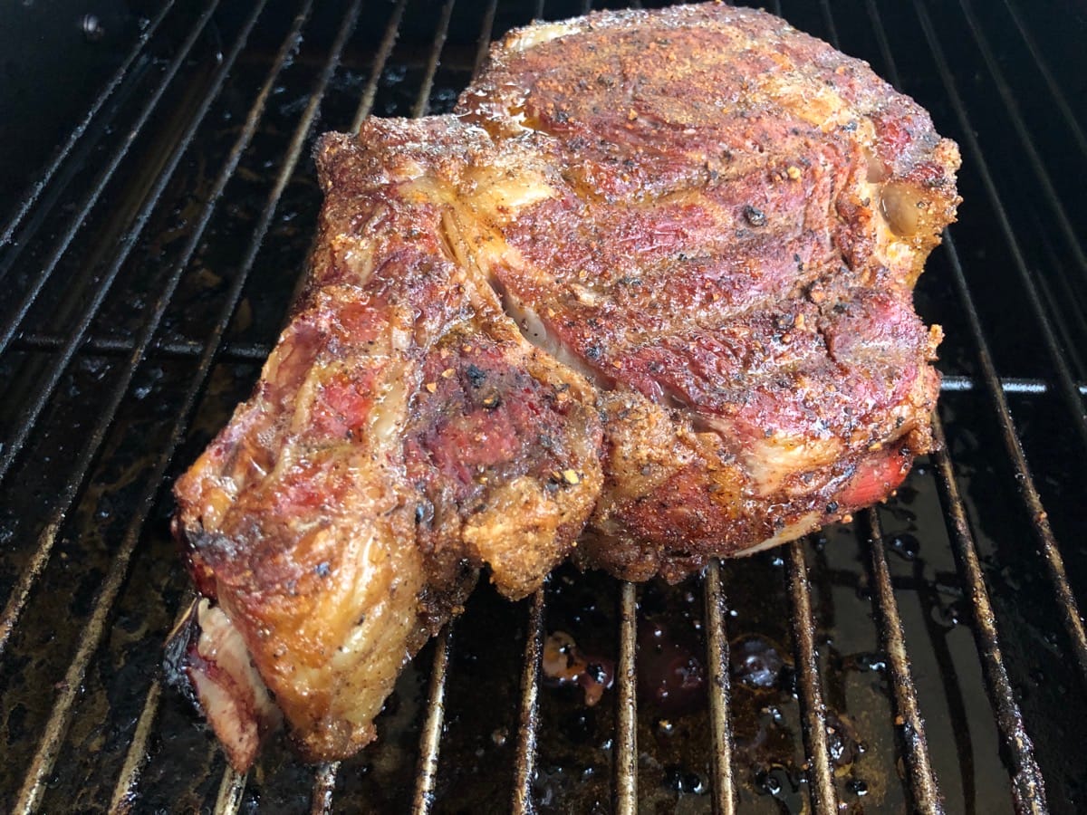 3lb Bone-in Ribeye slowly cooking in MAK 2 Star pellet grill side smoker. The steak started to get some beautiful color before we ever grilled it on the MAK searing grates.