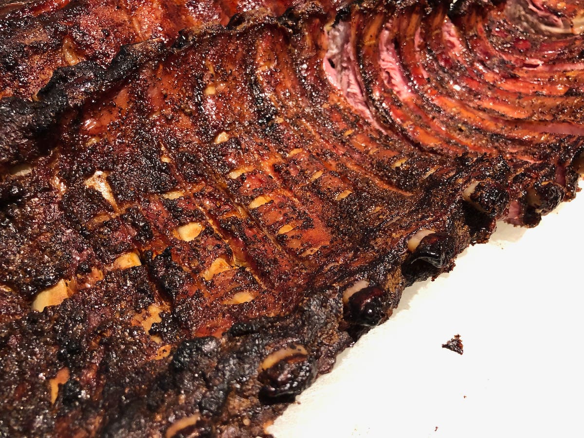 The scored membrane shrunk on the bone to create a one of a kind rib eating experience. As you peel this off while eating, you will be hog heaven.