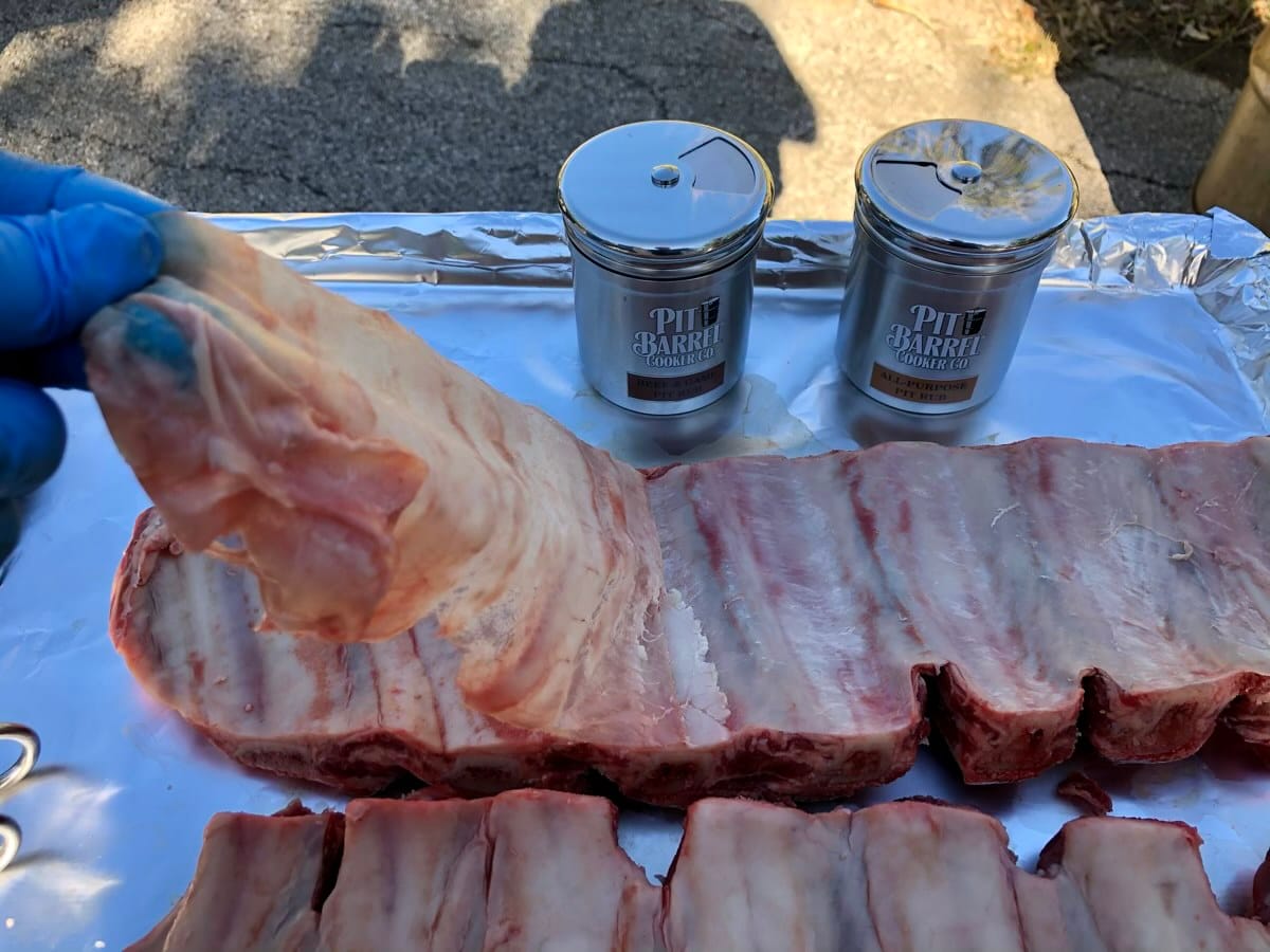 Removing membrane on back of beef finger ribs.