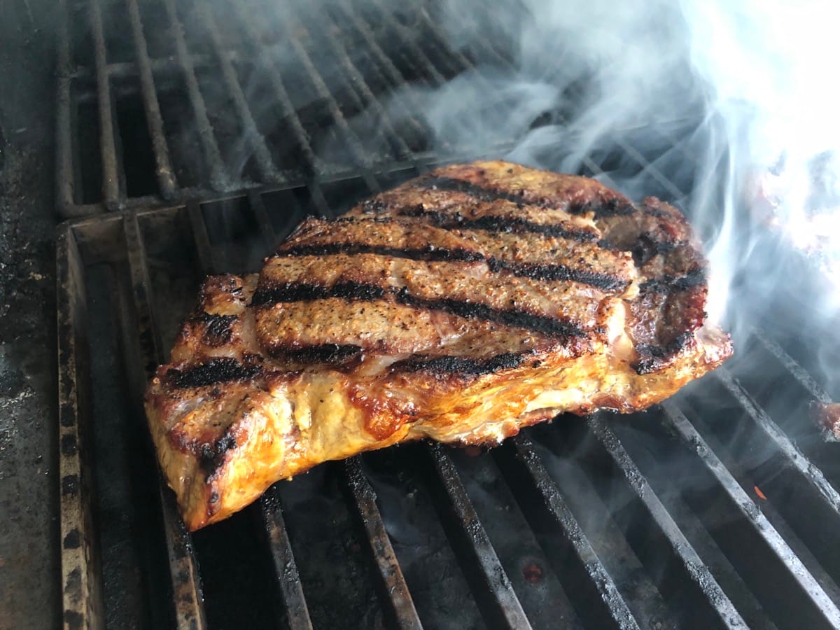 Ribeye steak sizzling on MAK Searing Grate.