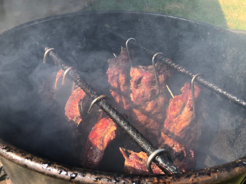 Seven racks of baby back ribs being cooked on 18.5” Pit Barrel Cooker