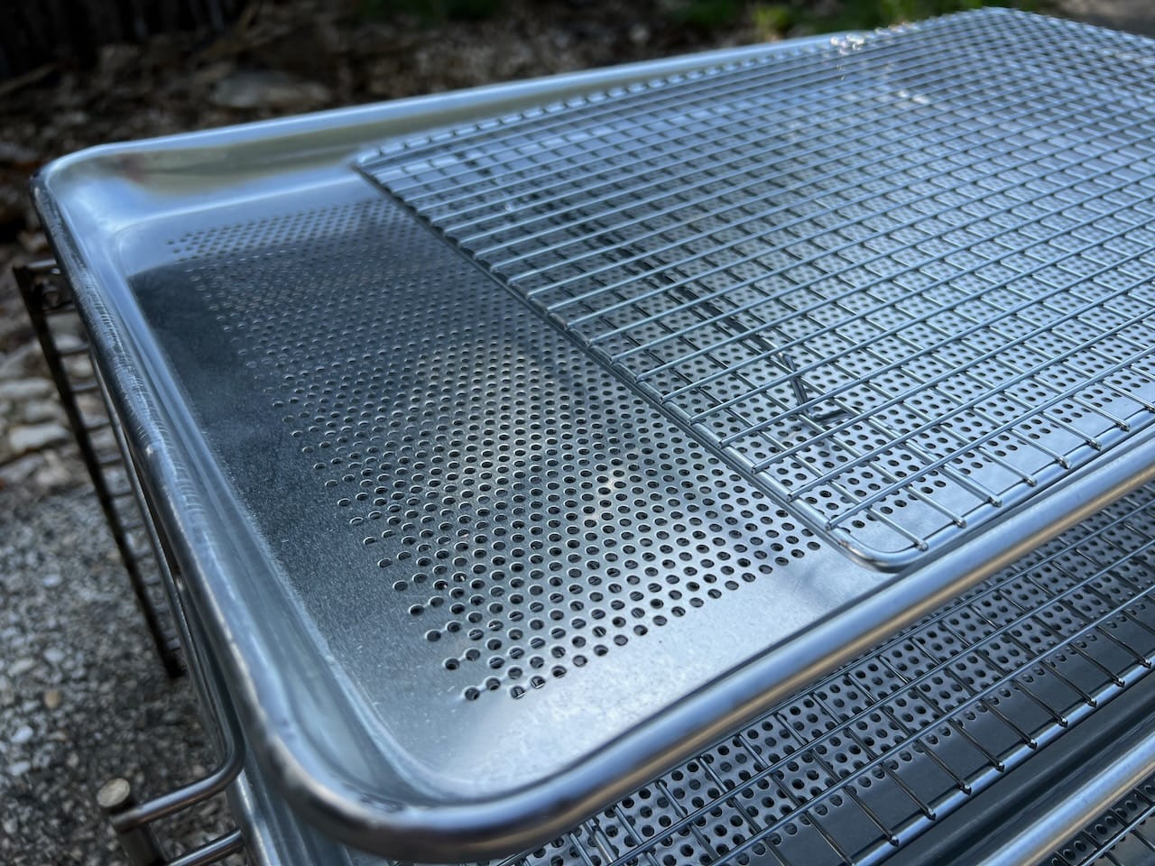 Perforated trays with wire grid racks.