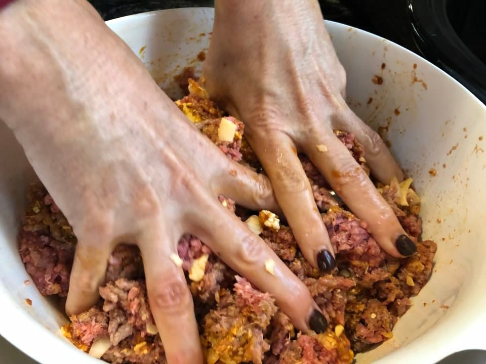 Mixing meatloaf ingredients