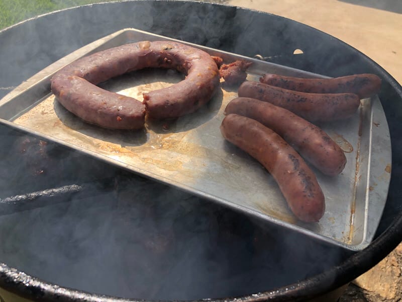 Smoking jalapeno sausage across the top of the Pit Barrel Cooker. You will need a low sided baking or cookie sheet as there is limited room once the lid is put back on.