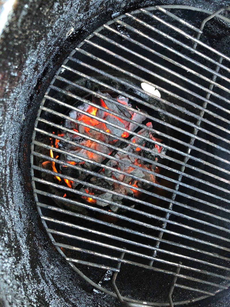 Blazing hot charcoal fire in Pit Barrel Cooker for cooking steaks