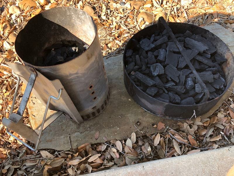 Weber charcoal chimney next to Pit Barrel Cooker fire basket.