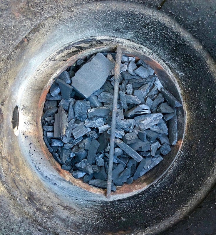 Rockwood Lump Charcoal in the Pit Barrel Cooker charcoal basket at the bottom of the barrel. Half a basket of charcoal will suffice for a rib cook. 