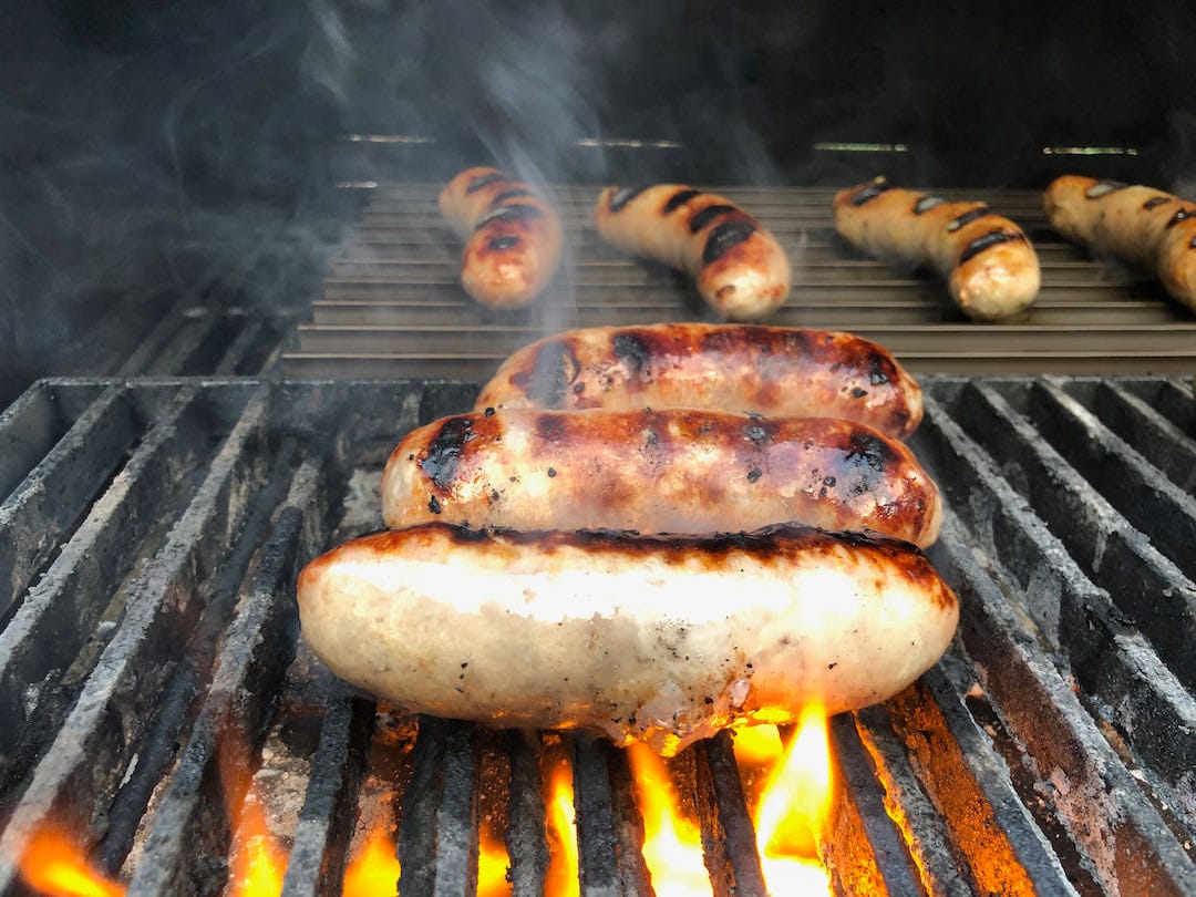 Sausages cooking on MAK and Grill Grates Brand Searing Grates.