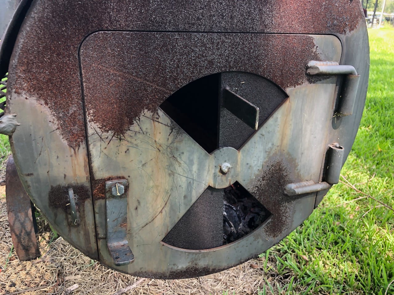 Firebox door on our older offset smoker with vents and recessed door.