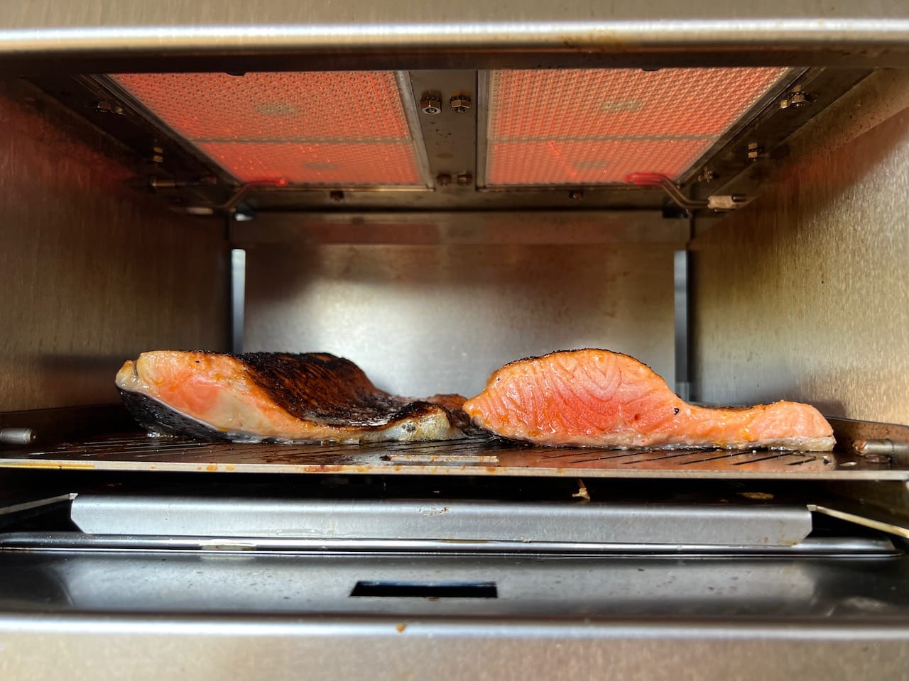 Salmon filets cooking at lowest setting in the Schwank Infrared Grill.